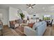 An open-concept living room with stylish furniture, neutral tones, and plenty of natural light at 14004 Emerald Fields Dr, Hudson, FL 34667