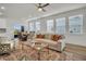 Bright living room with a dining space, featuring natural light, neutral tones, and stylish furniture at 14004 Emerald Fields Dr, Hudson, FL 34667