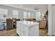 A view of the open concept showing kitchen island, dining and living space with lots of natural light at 14004 Emerald Fields Dr, Hudson, FL 34667