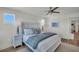 Large primary bedroom featuring light walls, a ceiling fan, and natural light at 14012 Emerald Fields Dr, Hudson, FL 34667