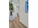 Hallway with luxury vinyl plank flooring and a view into the kitchen and living room at 14012 Emerald Fields Dr, Hudson, FL 34667