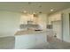 Spacious kitchen featuring an island, stainless sink, and white cabinetry at 14012 Emerald Fields Dr, Hudson, FL 34667