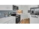 Modern kitchen with stainless steel appliances, white countertops and stylish backsplash at 14012 Emerald Fields Dr, Hudson, FL 34667