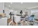 Spacious living and dining area connected to a modern kitchen with stainless steel appliances at 14012 Emerald Fields Dr, Hudson, FL 34667