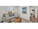 Living room with a comfortable gray sofa, woven coffee table, and bright natural lighting at 14012 Emerald Fields Dr, Hudson, FL 34667