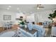 Open-concept living area with a dining table, kitchen, and a comfortable seating area at 14012 Emerald Fields Dr, Hudson, FL 34667