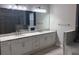 Elegant bathroom boasting double vanities, granite countertops, and an oversized mirror at 16617 5Th E Ave, Bradenton, FL 34212