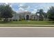 Charming one-story home features a tile roof, lush landscaping, and a well-manicured lawn at 16617 5Th E Ave, Bradenton, FL 34212