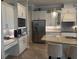 Modern kitchen with white cabinetry, stainless steel appliances, and a granite countertop island at 16617 5Th E Ave, Bradenton, FL 34212