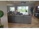 Open living room with gray sofa, wood floors, and sliding glass doors to a screened outdoor area at 16617 5Th E Ave, Bradenton, FL 34212
