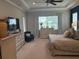 Spacious main bedroom with tray ceiling, neutral carpet, and large windows overlooking the backyard at 16617 5Th E Ave, Bradenton, FL 34212