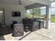 Outdoor kitchen features modern appliances, a bar, and a seating area, perfect for entertaining guests at 16617 5Th E Ave, Bradenton, FL 34212