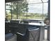 A full outdoor kitchen setup includes a grill, seating, and beautiful views of the pool and surrounding landscape at 16617 5Th E Ave, Bradenton, FL 34212