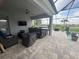 Spacious outdoor living area featuring a complete kitchen, seating, and serene views of the landscaped backyard at 16617 5Th E Ave, Bradenton, FL 34212