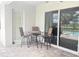 Cozy outdoor patio with bar seating and a view of the pool and lake through sliding glass doors at 16617 5Th E Ave, Bradenton, FL 34212