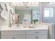 Bright bathroom boasts a glass enclosed shower, and elegant white vanity at 16818 Fiesta Dr, Port Charlotte, FL 33953