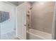 Bright bathroom with a shower-over-tub combination and a tiled surround at 16818 Fiesta Dr, Port Charlotte, FL 33953