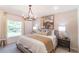 Bright bedroom with a large window, chandelier, and textured wallpaper creates a relaxing atmosphere at 16818 Fiesta Dr, Port Charlotte, FL 33953