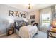 Cozy bedroom features a decorative wallpaper, desk area and a modern ceiling fan at 16818 Fiesta Dr, Port Charlotte, FL 33953
