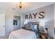Inviting bedroom featuring a decorative wallpaper, modern light fixture, and spacious closet at 16818 Fiesta Dr, Port Charlotte, FL 33953