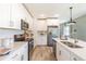 Contemporary kitchen featuring sleek appliances, countertops, and cabinetry at 16818 Fiesta Dr, Port Charlotte, FL 33953