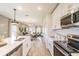 Stylish kitchen with white cabinets, island, and a view into the dining and living areas at 16818 Fiesta Dr, Port Charlotte, FL 33953