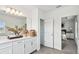 Bathroom with double vanity, large mirror and access to the ensuite main bedroom at 16836 Fiesta Dr, Port Charlotte, FL 33953
