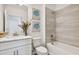 Bright bathroom with a shower over tub, single vanity and decorative artwork at 16836 Fiesta Dr, Port Charlotte, FL 33953