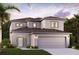 Two-story home featuring a modern design, a neutral color palette, an attached two-car garage, and manicured landscaping at 16836 Fiesta Dr, Port Charlotte, FL 33953