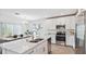 Kitchen island with seating, stainless steel sink and stainless steel appliances at 16836 Fiesta Dr, Port Charlotte, FL 33953