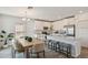 Eat-in kitchen with a center island, modern stainless steel appliances and white cabinets at 16836 Fiesta Dr, Port Charlotte, FL 33953