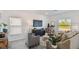 Bright living room featuring modern furnishings, neutral color palette and large windows offering plenty of natural light at 16836 Fiesta Dr, Port Charlotte, FL 33953