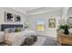 Bright main bedroom with a tray ceiling, ensuite bathroom and large window offering plenty of natural light at 16836 Fiesta Dr, Port Charlotte, FL 33953