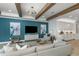 Cozy living room with stylish decor, a plush sofa, and bright natural light create an inviting and relaxing atmosphere at 1688 Lugano Cir, North Venice, FL 34275