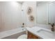 Well-lit bathroom features a combined tub and shower, stylish fixtures, and modern decor for a relaxing experience at 200 Vistera Blvd, North Venice, FL 34275