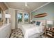 Light-filled bedroom with decorative surfboard and plush rug, offering a relaxed and stylish space at 200 Vistera Blvd, North Venice, FL 34275