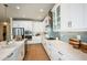 Bright kitchen featuring white cabinets, stainless steel appliances, tiled backsplash, and wooden floors at 200 Vistera Blvd, North Venice, FL 34275