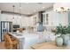 Modern kitchen with white cabinets, stainless steel appliances, a center island with seating, and decorative lighting at 200 Vistera Blvd, North Venice, FL 34275