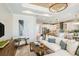 Open-concept living room flowing into a modern kitchen, featuring a plush sofa and stylish decor at 200 Vistera Blvd, North Venice, FL 34275