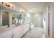 Spacious main bathroom features a double vanity, soaking tub, and a separate glass-enclosed shower at 200 Vistera Blvd, North Venice, FL 34275