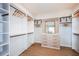 Spacious walk-in closet with custom shelves, ample hanging space, and a built-in dresser with a mirror at 200 Vistera Blvd, North Venice, FL 34275