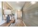 Bright hallway with stylish wood-look flooring, shiplap accent wall, and a decorative console table at 2046 Sunset Preserve Way, Port Charlotte, FL 33953