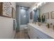 Bright bathroom featuring a shower/tub combo, double vanity, and stylish decor at 236 Vistera Blvd, Nokomis, FL 34275