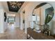 Inviting foyer with decorative light fixture, mirror, and view of the living room at 236 Vistera Blvd, Nokomis, FL 34275