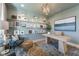 Stylish home office with pale blue walls, built in shelving, comfortable seating and modern desk at 236 Vistera Blvd, Nokomis, FL 34275