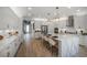 Well-lit kitchen featuring white cabinets, stainless steel appliances, and a large island with seating at 236 Vistera Blvd, Nokomis, FL 34275