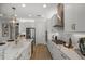 Bright kitchen with modern appliances, white cabinetry, stylish countertops, and tile backsplash at 236 Vistera Blvd, Nokomis, FL 34275