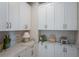 Well-organized laundry room with plenty of cabinet space and countertop for folding at 236 Vistera Blvd, Nokomis, FL 34275