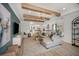 Open-concept living room with wood beam ceiling, stylish decor, and seamless flow to the kitchen at 236 Vistera Blvd, Nokomis, FL 34275
