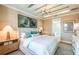 Serene main bedroom features neutral tones, elegant lighting, and a view into the ensuite bathroom at 237 Vistera Blvd, North Venice, FL 34275